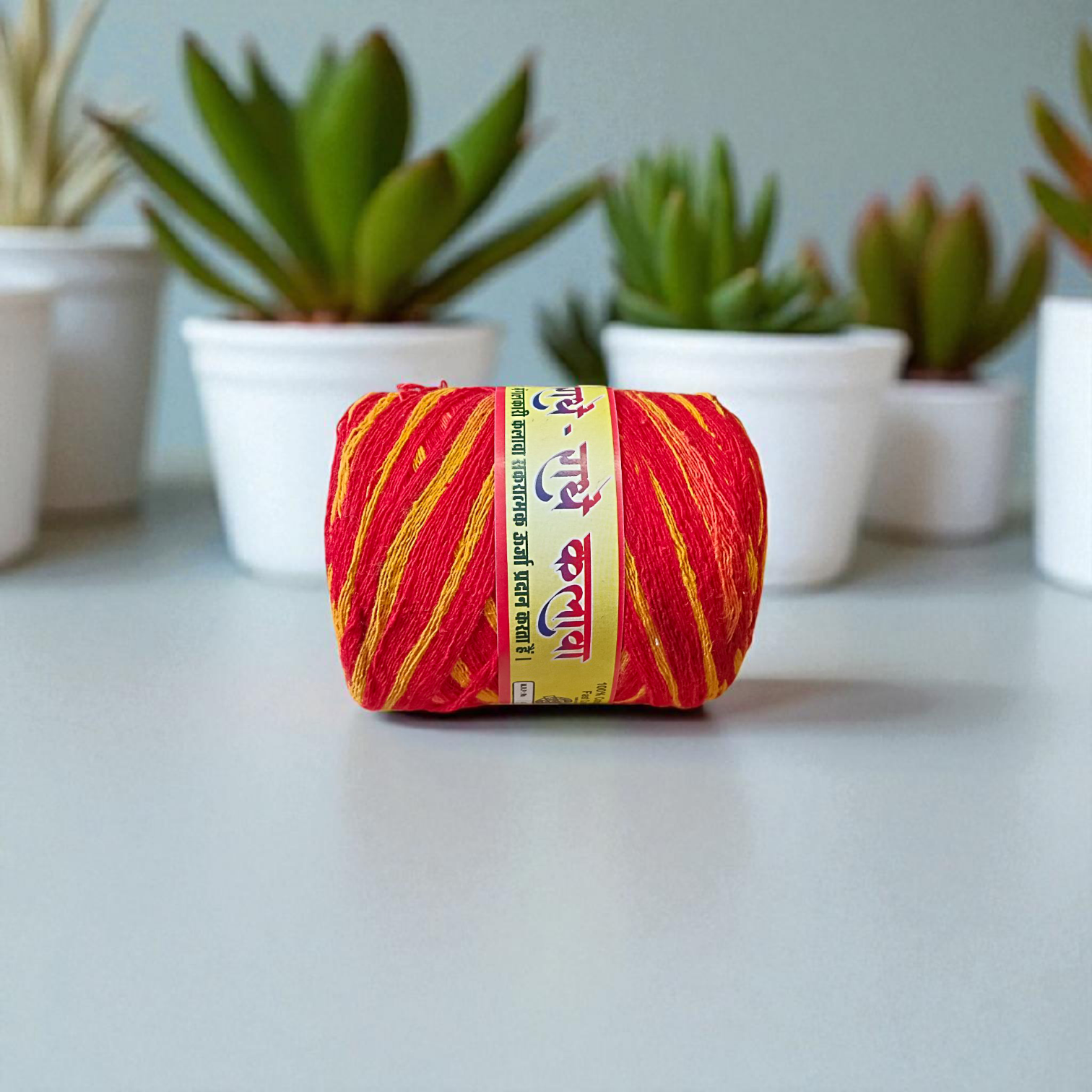 Extra-large red and yellow twisted cotton Moli Kalawa thread rolled neatly, ideal for pooja and Raksha Bandhan rituals