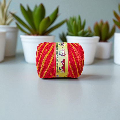 Extra-large red and yellow twisted cotton Moli Kalawa thread rolled neatly, ideal for pooja and Raksha Bandhan rituals