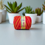 Extra-large red and yellow twisted cotton Moli Kalawa thread rolled neatly, ideal for pooja and Raksha Bandhan rituals