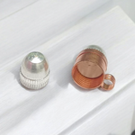 Five stylish cylindrical copper and golden metal taweez displayed with Bhojpatra sheets on a clean background