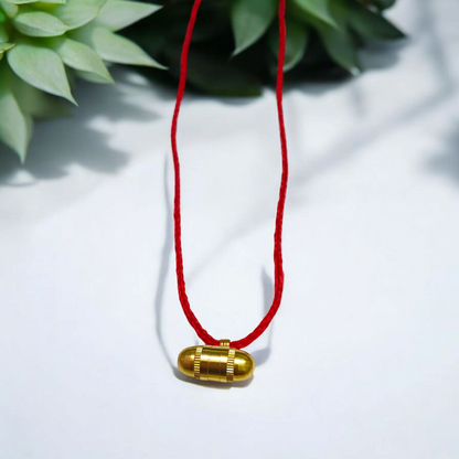 Five stylish cylindrical copper and golden metal taweez displayed with Bhojpatra sheets on a clean background