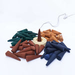 Four assorted natural dhoop cones from MALAWALA with smoke trail and decorative background, representing spiritual and calming use in home or temple