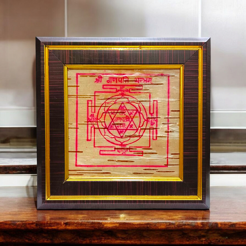 Framed Ganpati Yantra inscribed on natural Bhojpatra, with sacred symbols and wooden casing for display