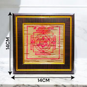 Framed Ganpati Yantra inscribed on natural Bhojpatra, with sacred symbols and wooden casing for display