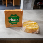 Golden-brown Labhganga Gold Loban resin pieces in a pouch, ready for hawan and pooja rituals