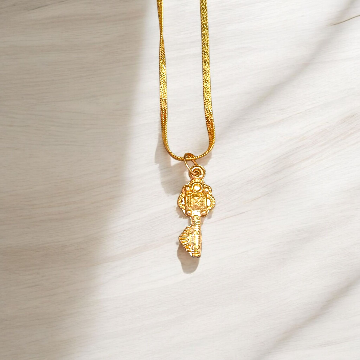 Golden Kuber Kunji locket with matching chain, designed for daily wear and believed to attract wealth and prosperity