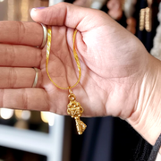 Golden Kuber Kunji locket with matching chain, designed for daily wear and believed to attract wealth and prosperity