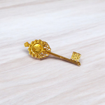Golden antique-style Kuber Kunji Key with sacred symbols and yantra, used for attracting wealth and financial prosperity at home or office