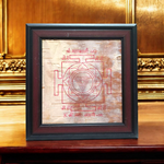 Hand-inscribed Mahakali Yantra on Bhojpatra with red ink, enclosed in a wooden frame, ideal for spiritual protection and tantric worship