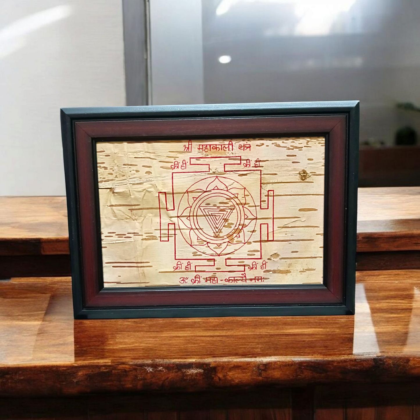 Hand-inscribed Mahakali Yantra on Bhojpatra with red ink, enclosed in a wooden frame, ideal for spiritual protection and tantric worship