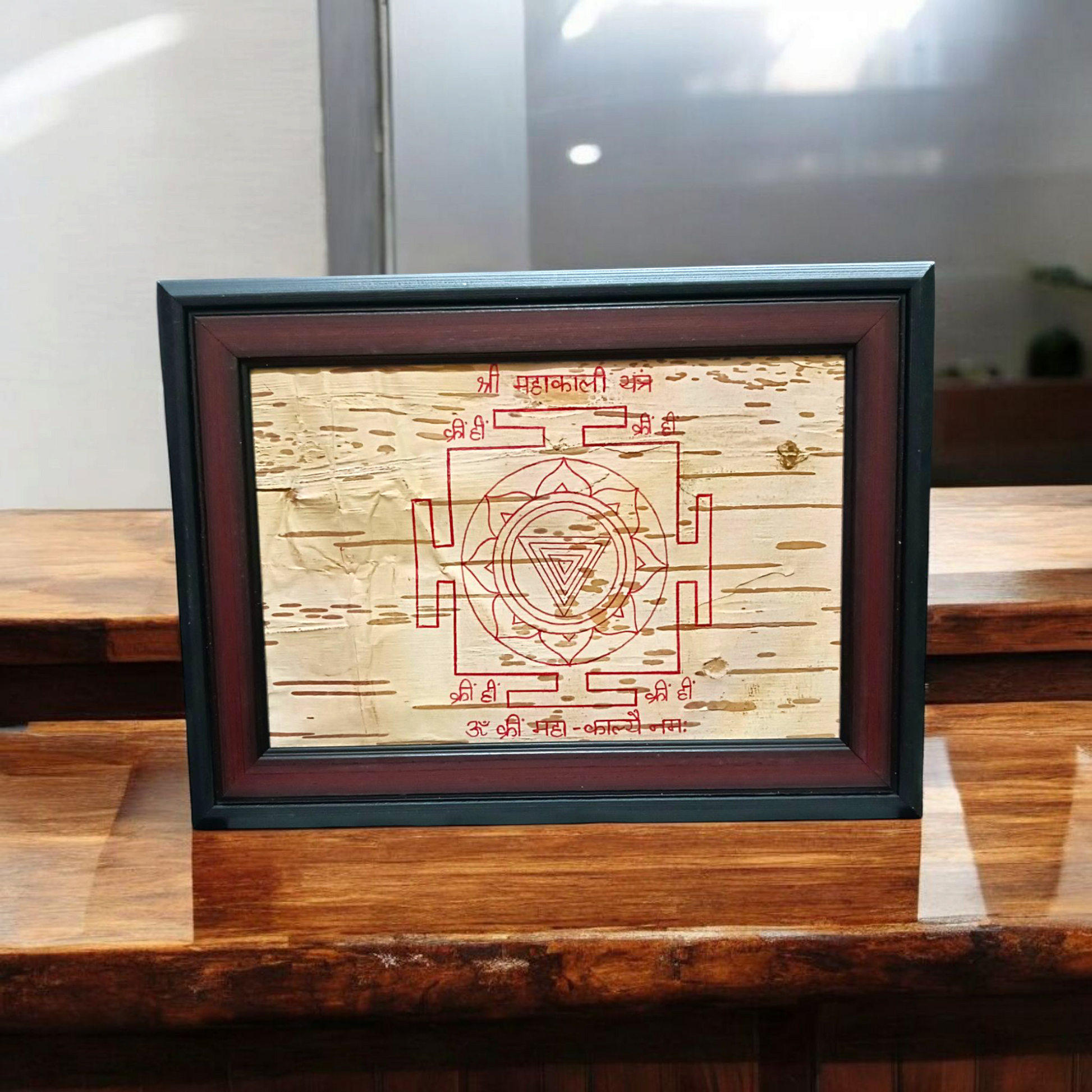 Hand-inscribed Mahakali Yantra on Bhojpatra with red ink, enclosed in a wooden frame, ideal for spiritual protection and tantric worship