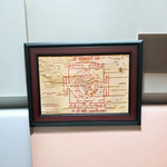 Hand-inscribed Mahakali Yantra on Bhojpatra with red ink, enclosed in a wooden frame, ideal for spiritual protection and tantric worship