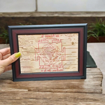 Hand-inscribed Mahakali Yantra on Bhojpatra with red ink, enclosed in a wooden frame, ideal for spiritual protection and tantric worship