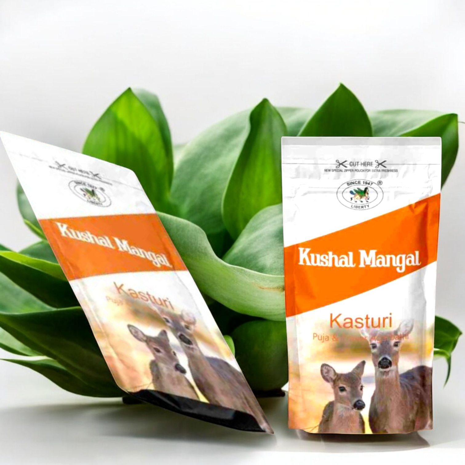 Hand-rolled Kasturi incense sticks with traditional Indian packaging placed beside a lit diya and fresh marigold flowers