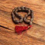 Handcrafted Kamal Gutta Mala made from natural lotus seed beads, available in 27+1 and 108+1 bead variants with a spiritual guru bead and certificate