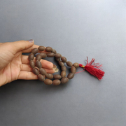Handcrafted Kamal Gutta Mala made from natural lotus seed beads, available in 27+1 and 108+1 bead variants with a spiritual guru bead and certificate
