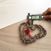 Handcrafted Kamal Gutta Mala made from natural lotus seed beads, available in 27+1 and 108+1 bead variants with a spiritual guru bead and certificate