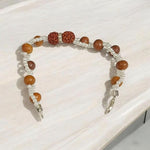 Handcrafted Natural Rudraksha & White Sandalwood Bracelet with 8mm beads on elastic thread, designed for spiritual wellness