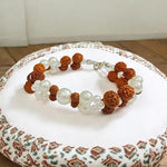 Handcrafted Natural Rudraksha and Pearl Bracelet with adjustable elastic design by Malawala