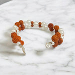 Handcrafted Natural Rudraksha and Pearl Bracelet with adjustable elastic design by Malawala