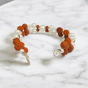 Handcrafted Natural Rudraksha and Pearl Bracelet with adjustable elastic design by Malawala
