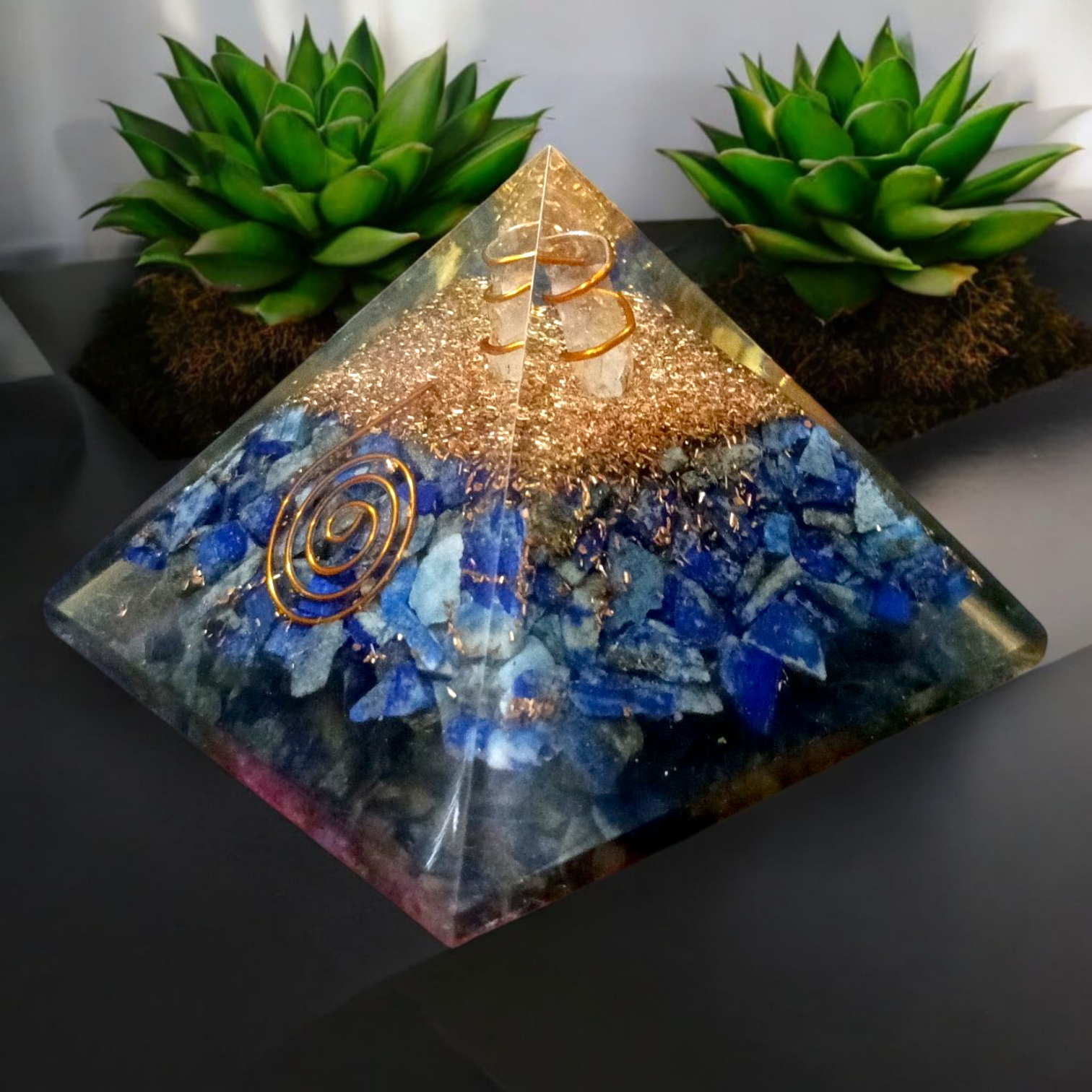 Handcrafted Orgone Pyramid made with natural Lapis Lazuli stones, copper spirals, and resin, designed for energy healing and EMF protection