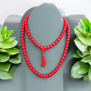 Handcrafted Red Hakik Mala made with natural Red Agate beads in 27+1 and 108+1 variants, placed on a wooden surface with lab certificate