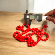 Handcrafted Red Hakik Mala made with natural Red Agate beads in 27+1 and 108+1 variants, placed on a wooden surface with lab certificate