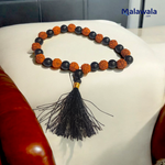 Handcrafted Rudraksha and Black Hakik mala with 5 Mukhi Rudraksha beads, used for protection, grounding, and meditation, available in 27+1 and 108+1 variants