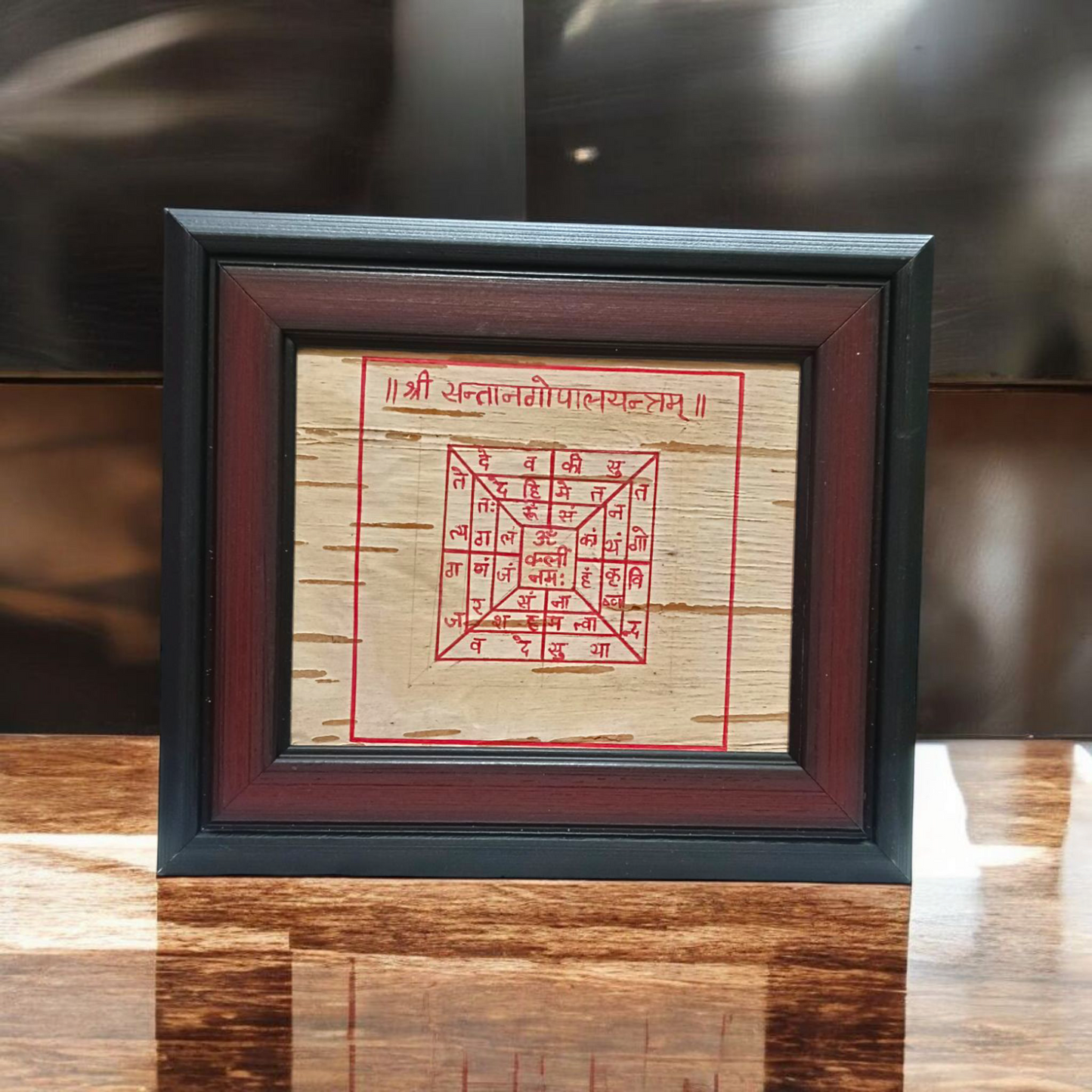 Handmade Santan Gopal Yantra on Bhojpatra enclosed in a wooden frame, used for pregnancy protection and blessings for childbirth