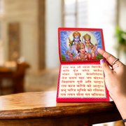 Hanuman Chalisa Hindi Book with colourful pages and devotional cover art placed near diya and flowers