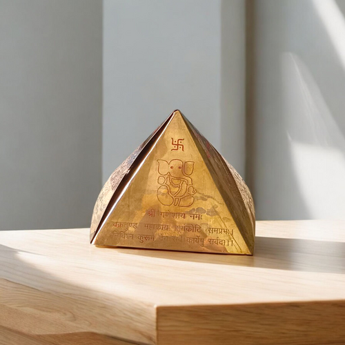 High-quality copper Vastu Pyramid Yantra with detailed etching, placed on a pillar top for energy correction