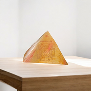 High-quality copper Vastu Pyramid Yantra with detailed etching, placed on a pillar top for energy correction