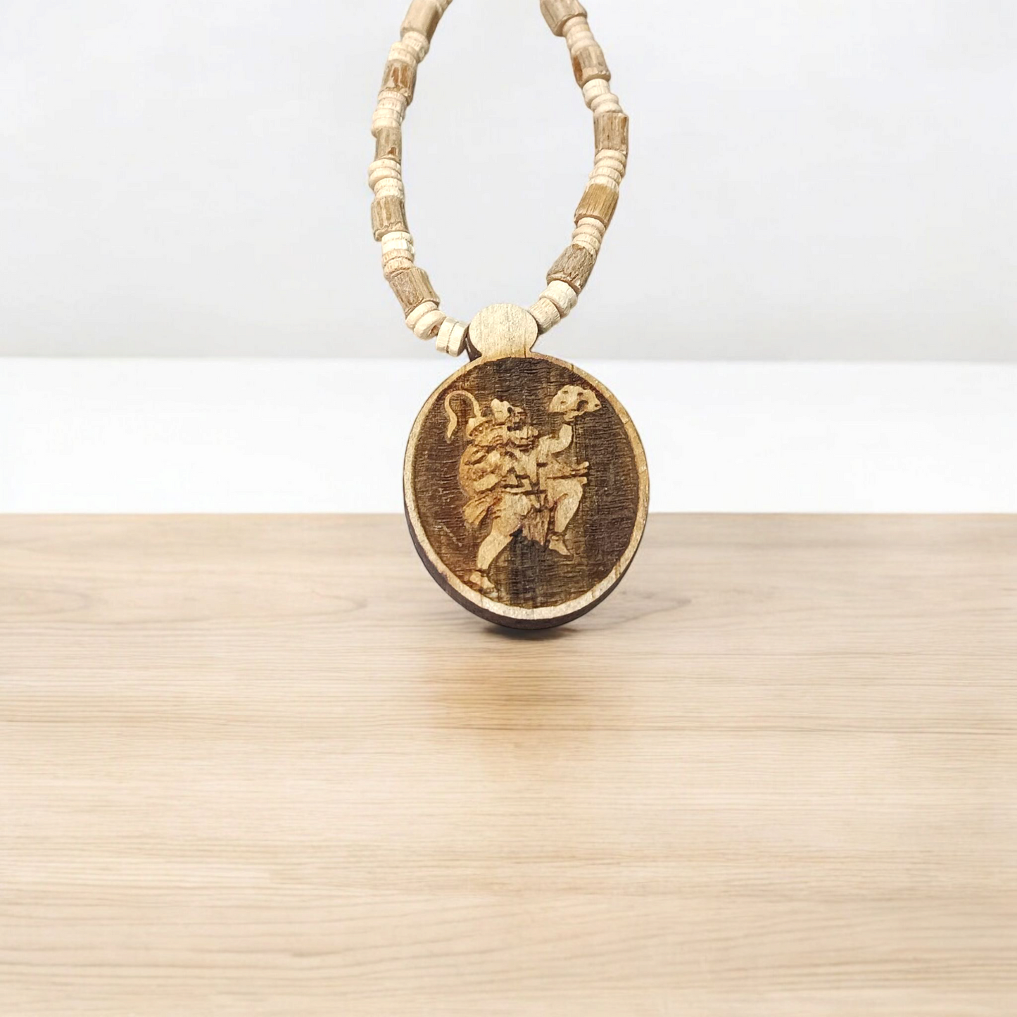 Image of Hanuman Ji Locket strung in Tulsi Mala with natural wood beads, placed on a white background