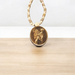 Image of Hanuman Ji Locket strung in Tulsi Mala with natural wood beads, placed on a white background