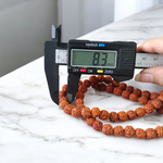 Image of Natural Rudraksha Jaap Mala with 54+1 beads, 8mm size, traditional hand-knotted design, ideal for meditation and chanting