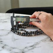 Image of Natural Sulemani Hakik (Black Agate) Mala with 108+1 and 27+1 polished 8mm round beads, displayed on a white background