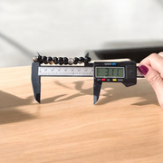 Image of Natural Sulemani Hakik Bracelet with 8mm round black agate beads in a stretchable design, displayed in a circular shape on a white surface