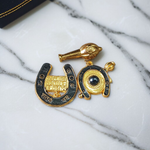 Image of Shani Kavach Set – Brass amulet with black thread placed on a traditional wooden tray with mustard seeds and oil lamp