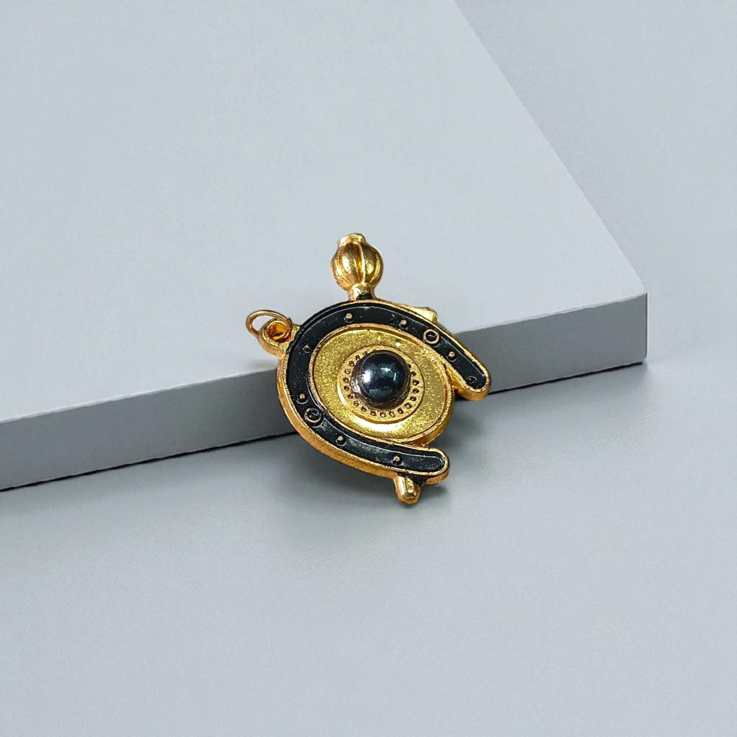 Image of Shani Kavach Set – Brass amulet with black thread placed on a traditional wooden tray with mustard seeds and oil lamp