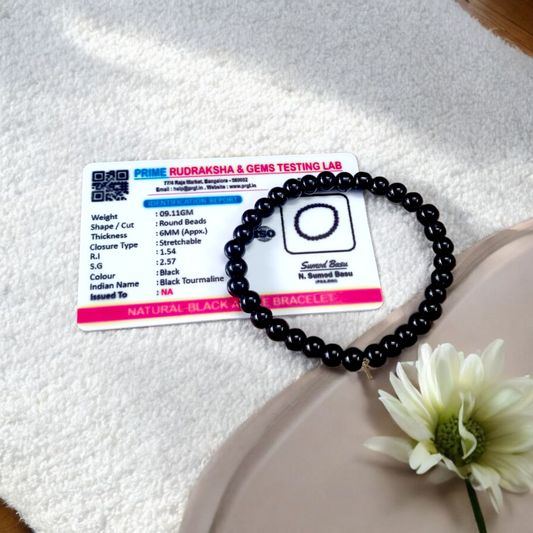 Image of a Black Agate (Black Hakik) bracelet with 6mm round beads arranged on a stretchable cord
