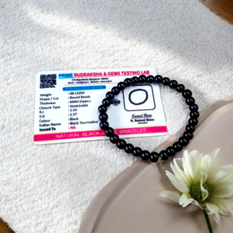 Image of a Black Agate (Black Hakik) bracelet with 6mm round beads arranged on a stretchable cord