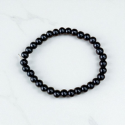 Image of a Black Agate (Black Hakik) bracelet with 6mm round beads arranged on a stretchable cord