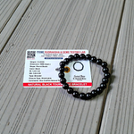 Image of a combo bracelet featuring 8mm golden Pyrite beads and glossy black Obsidian beads arranged side by side on a neutral background