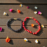 Image of a combo featuring two bracelets made of black and red Gunja seeds, arranged side by side on a clean white background