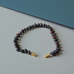 Image of a combo featuring two bracelets made of black and red Gunja seeds, arranged side by side on a clean white background