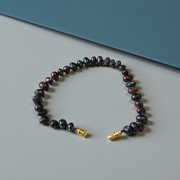 Image of a combo featuring two bracelets made of black and red Gunja seeds, arranged side by side on a clean white background