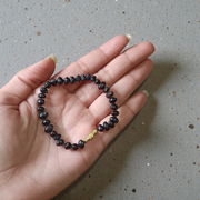 Image of a combo featuring two bracelets made of black and red Gunja seeds, arranged side by side on a clean white background