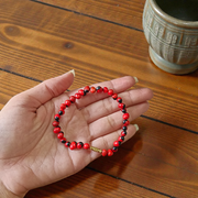Image of a combo featuring two bracelets made of black and red Gunja seeds, arranged side by side on a clean white background