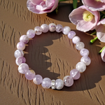 Image of a natural Amethyst bracelet with polished 8mm deep purple beads, arranged in a circular shape on a light background